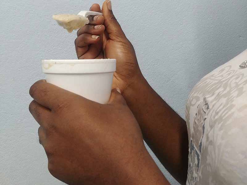 black girl drinking porridge