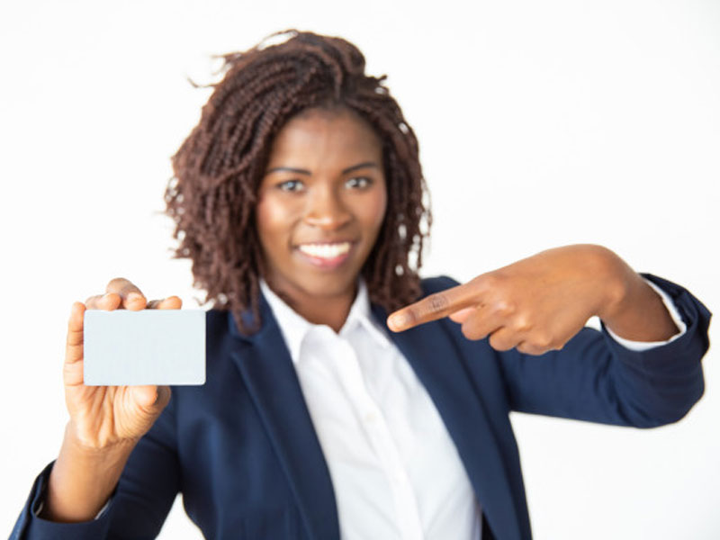 African black business woman pointing at blank business card – Free Photo