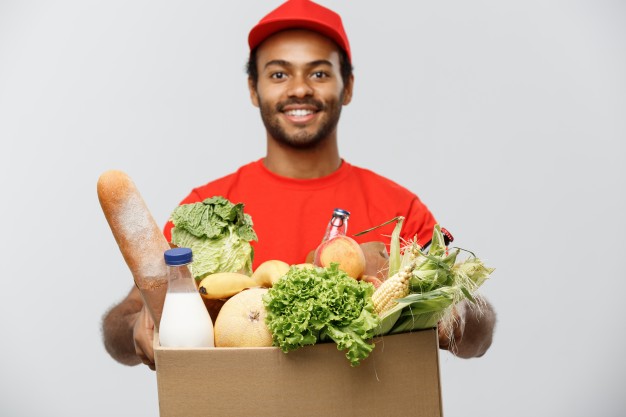 Delivery man – young black African american carrying box of grocery – Free Photo