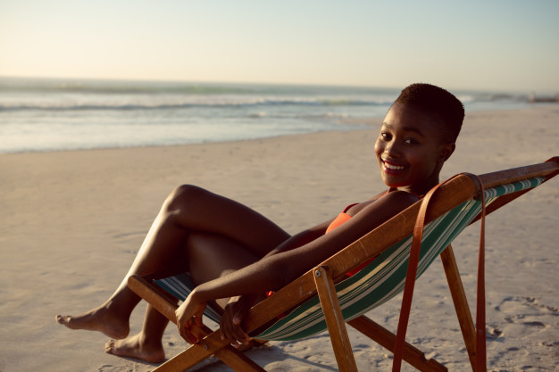 happy-woman-relaxing-beach-chair-beach_107420-9915