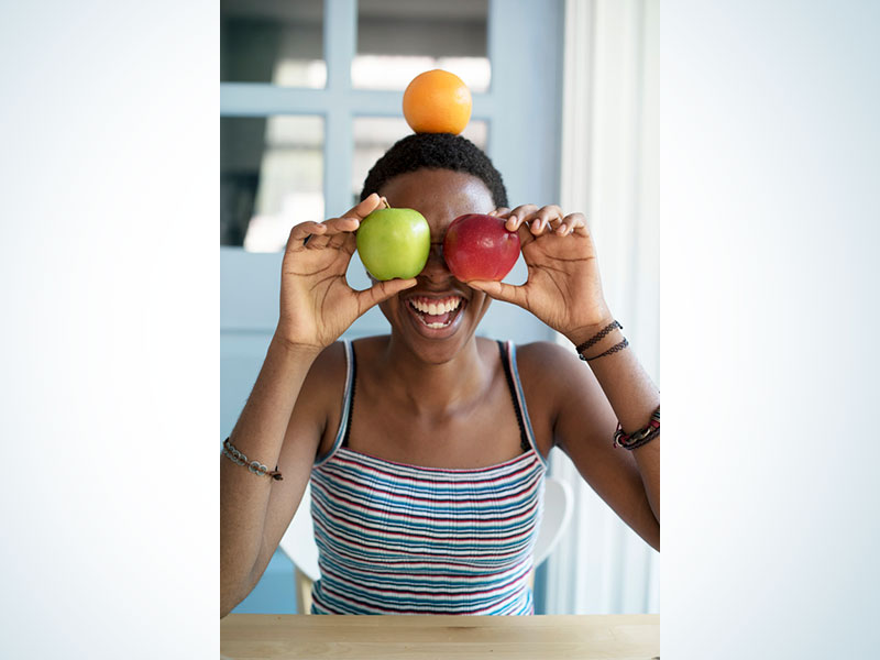 African descent woman with fruits on her face Free Photo