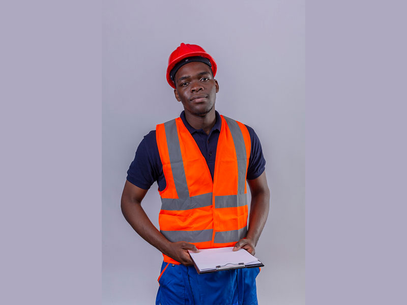 Young african american builder man wearing construction vest and safety helmet holding clipboard looking confident standing Free Photo