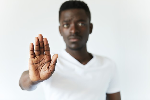 African American black man holding hand stop gesture