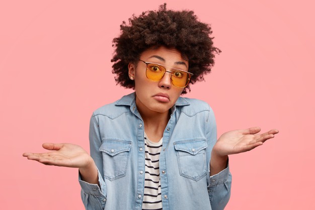 Puzzled African American Female With Clueless Expression Shrugs Shoulders Doesn T Know Answer Sees No Way Out Wears Fashionable Denim Clothes Sunglasses Models Indoor Pink Wall 273609 15673