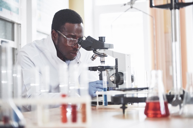 African American black scientist working microscope laboratory