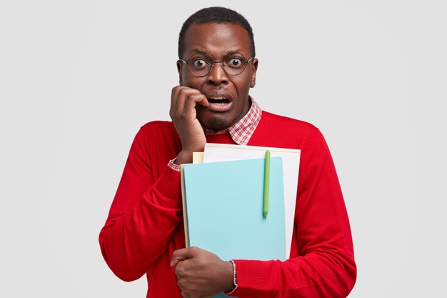 African black Frustrated male student with terrified expression