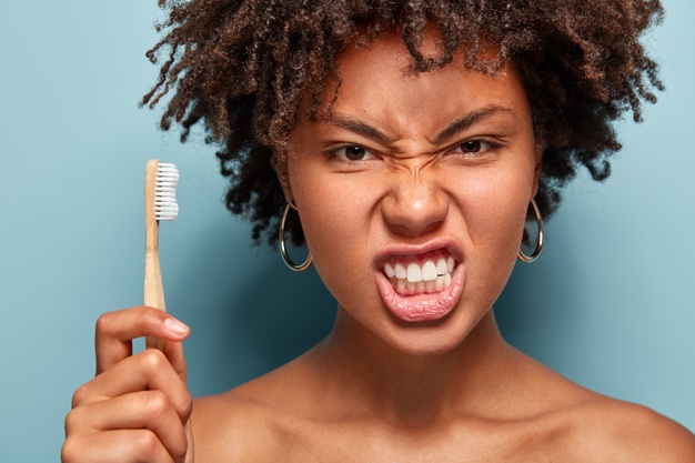 Close up African Black girl or woman brushing teeth – fighting cavities