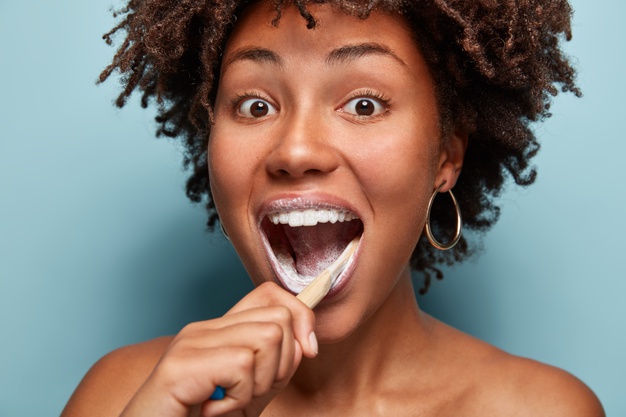 Dental Care Beauty Happiness Concept Positive Afro American Teen Girl Opens Mouth Widely Brushes Teeth Morning With Toothbrush Toothpaste Feels Happy Models Blue Wall 273609 26525