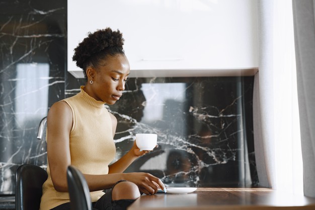 African Black woman drinking coffee – Free Photo