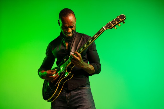 African black man musician playing the guitar like a rockstar
