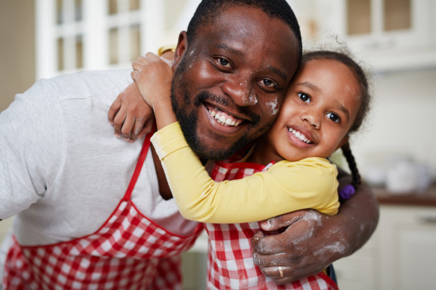 African black father and daughter – little girl cooking in the Kitchen