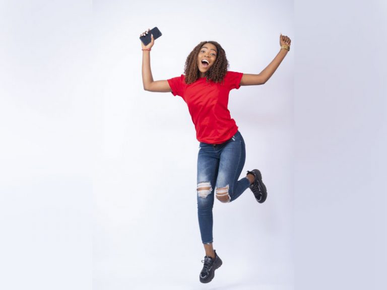 Happy African American black woman jumping in excitement - Cariblens