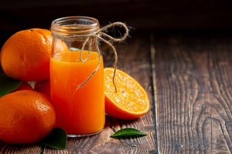 Fresh orange juice in the glass on dark wooden background Free Photo