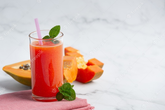 Glass of papaya juice put on white marble floor Free Photo