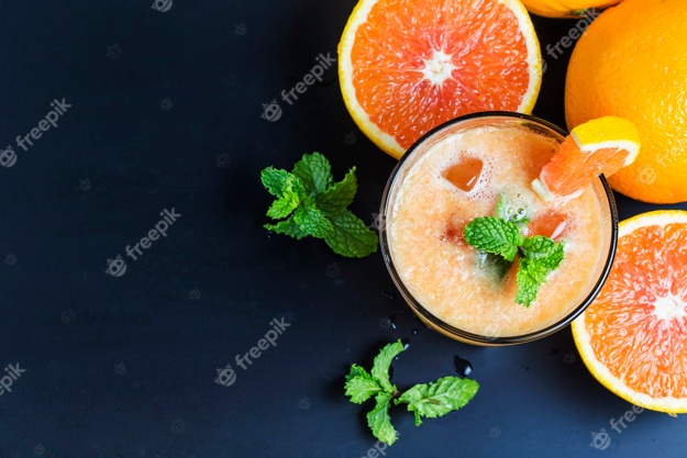 Juicy oranges with an orange juice Free Photo