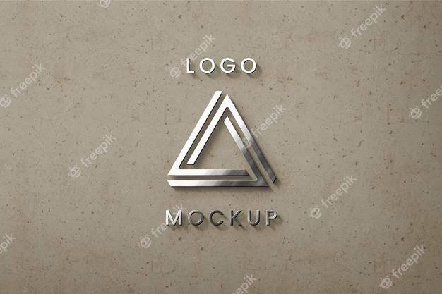 Silver logo on beige wall mockup Free Psd