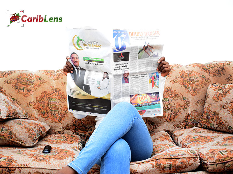 African Black Woman Reading Gleaner Newspaper