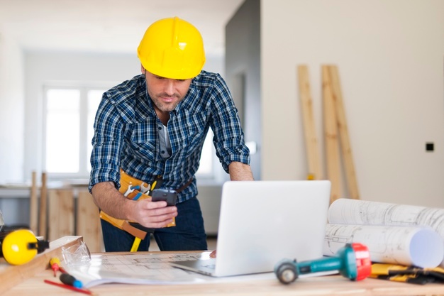 Busy building contractor at work Free Photo