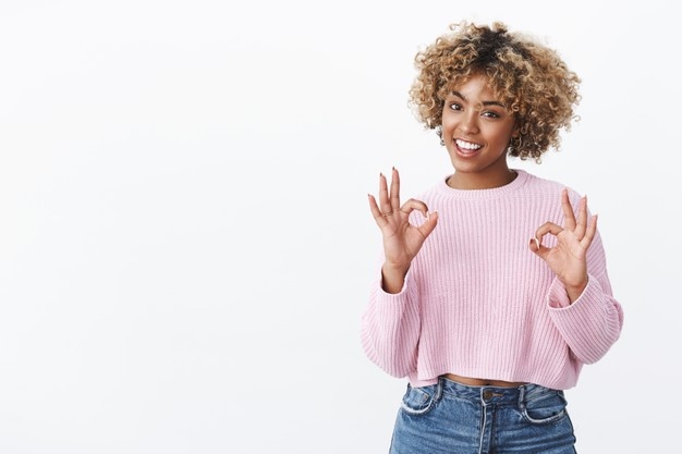 African-American showing ok sign or gesture and smiling