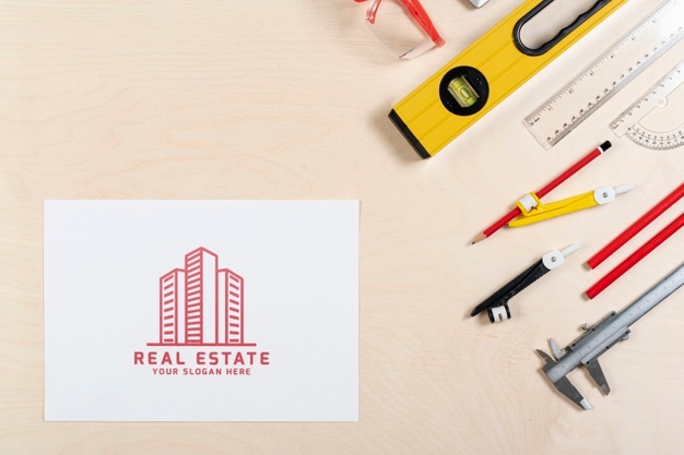 Real estate logo with buildings and stationery items Free Psd