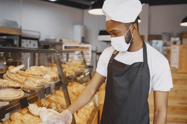 Baker in uniform giving advice about pastry. man wearing protective mask. buying fresh bread. Free Photo 5 months ago You may also like