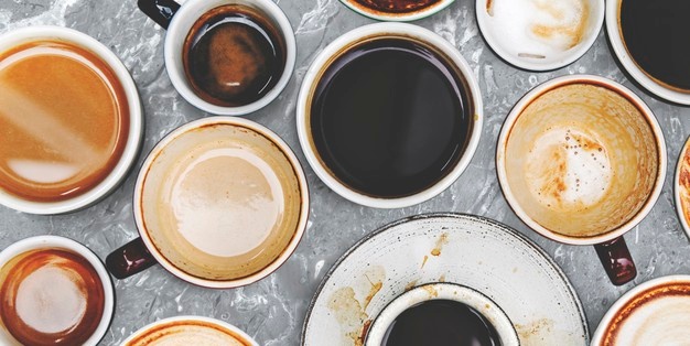 Assorted coffee cups on a marble background Free Photo