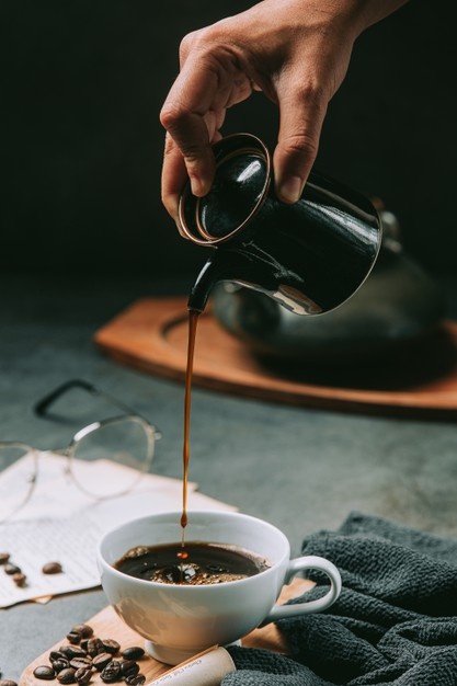 Close Up Hand Pouring Coffee Water Into Coffee Cup International Coffee Day Concept 1150 25432