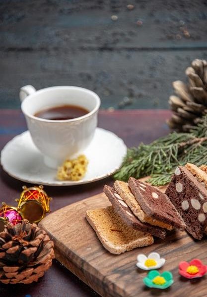 Front view cup of tea with cake slices on dark desk cake biscuit sugar cookie tea Free Photo