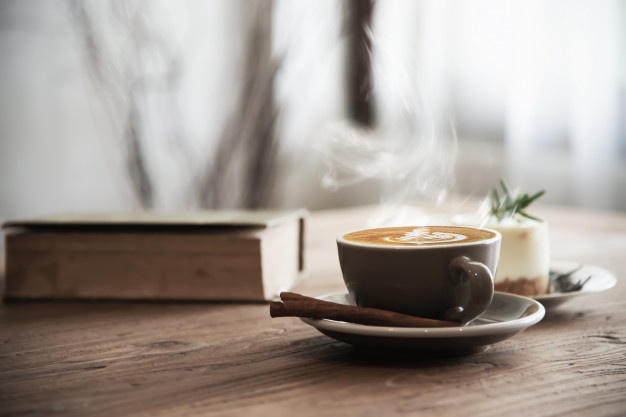 Hot coffee cup set on wooden table Free Photo