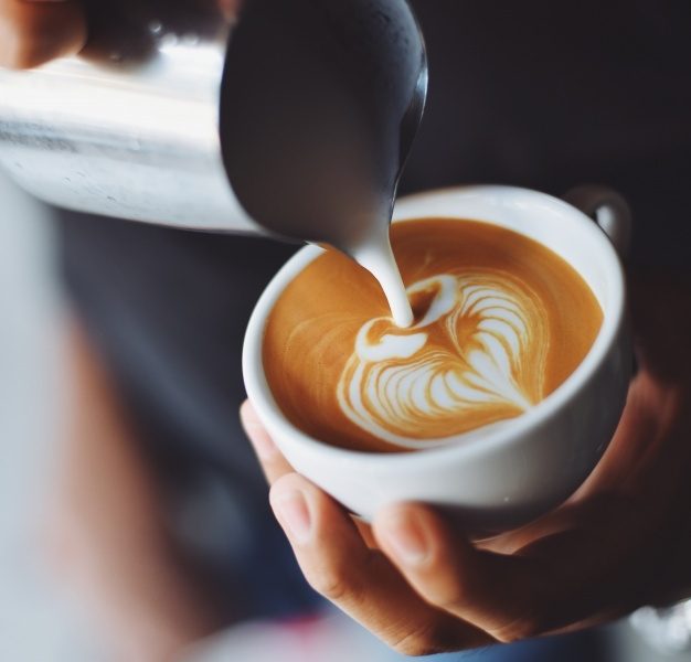 Person serving a cup of coffee Free Photo