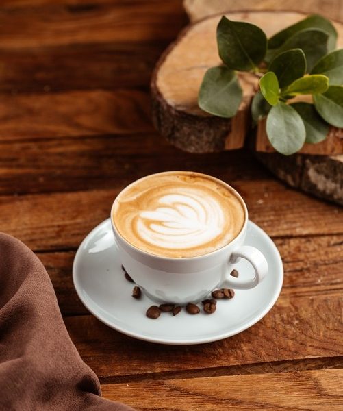 A top view hot espresso with brown coffee seeds on the brown wooden desk coffee cup drink Free Photo