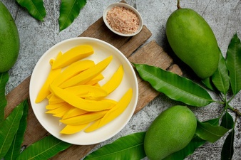 Pickled mango on dark wooden surface Free Photo