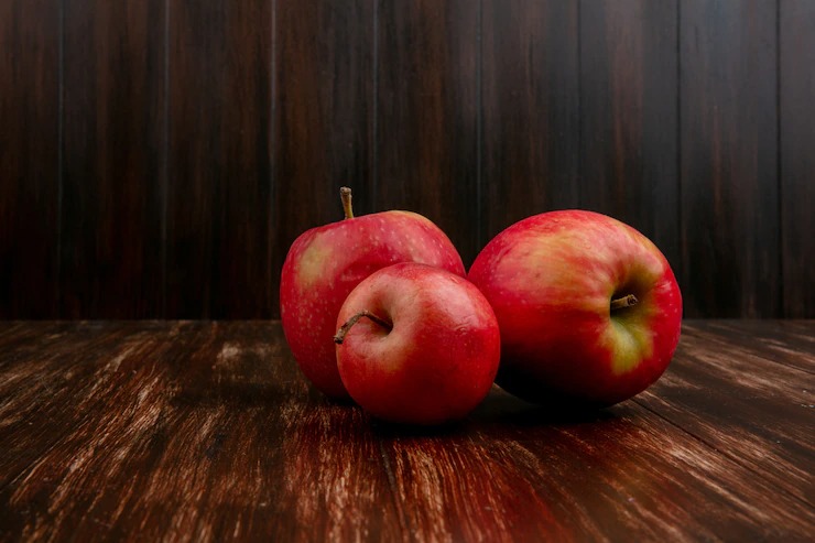 Front view red apples on a wooden background Free Photo