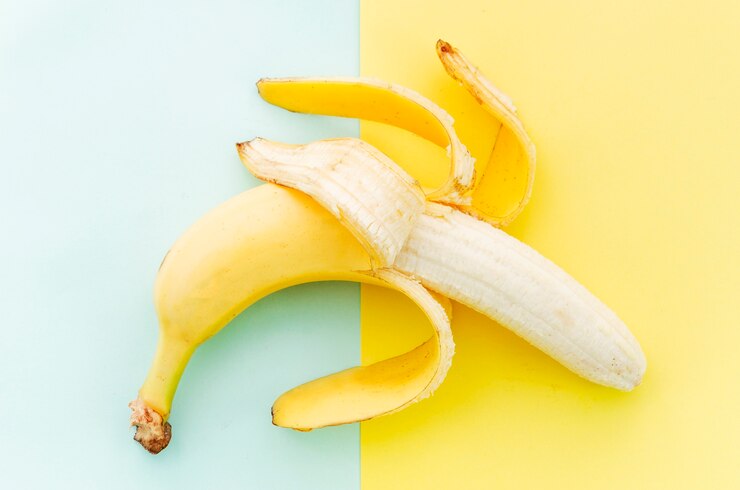 Cleared banana on colored surface Free Photo