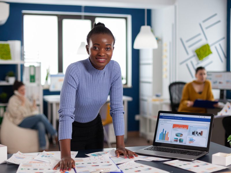 African American black woman or girl working in office with computer doing reports