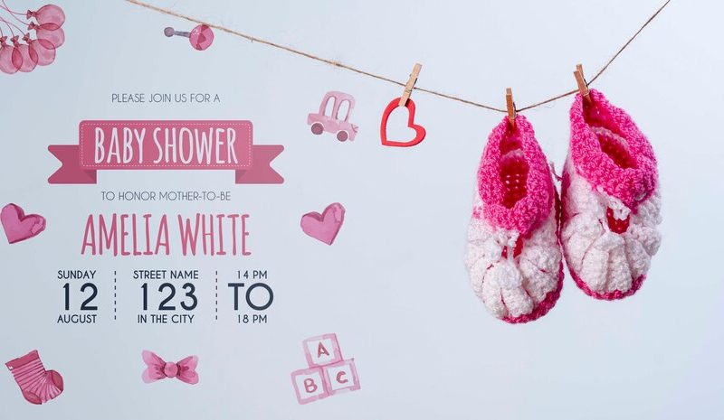 Front view of pink shoes and invitation for baby shower Free Psd