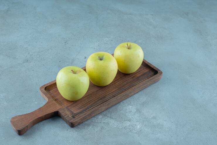 Green apples on a board , on the marble background. high quality photo Free Photo