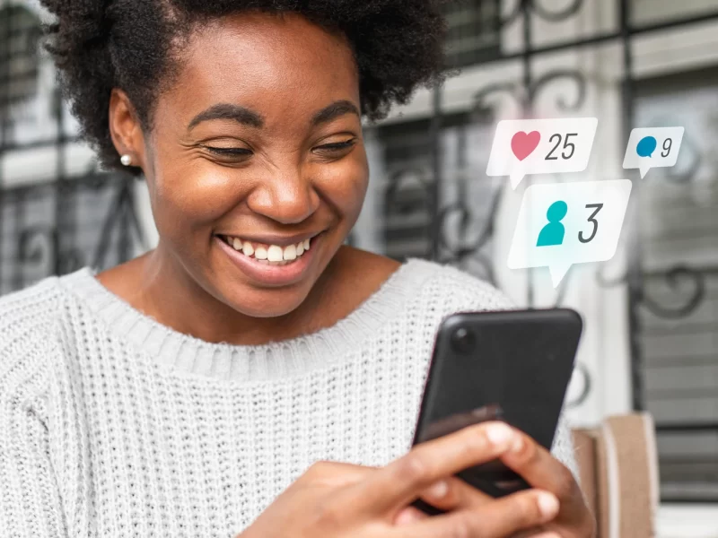 African black woman checking social media on a phone