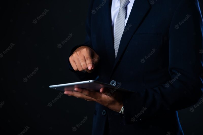 Businessman using tablet analyzing sales data and economic growth graph chart, technology Free