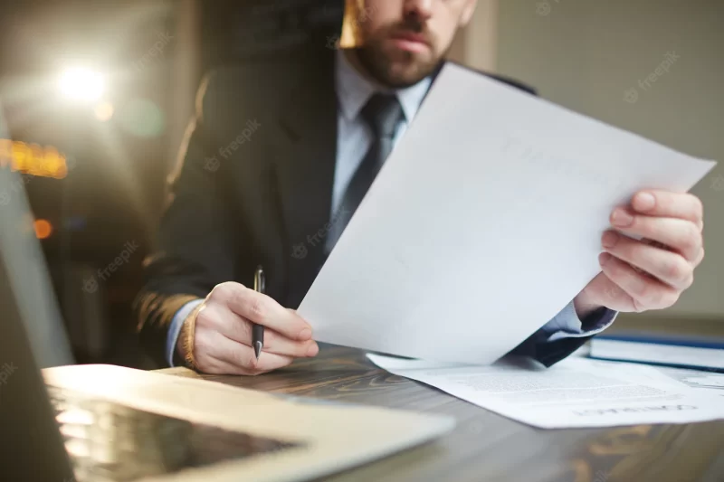 Businessman working with documentation at desk Free Photo