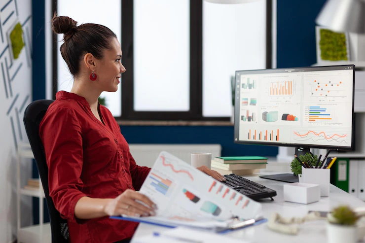 Businesswoman With Clipboard Sitting Desk Startup Business Office Smiling Employee Red Shirt Comparing Charts Successful Entrepreneur Looking Desktop Computer Analyze Business Data 482257 30229
