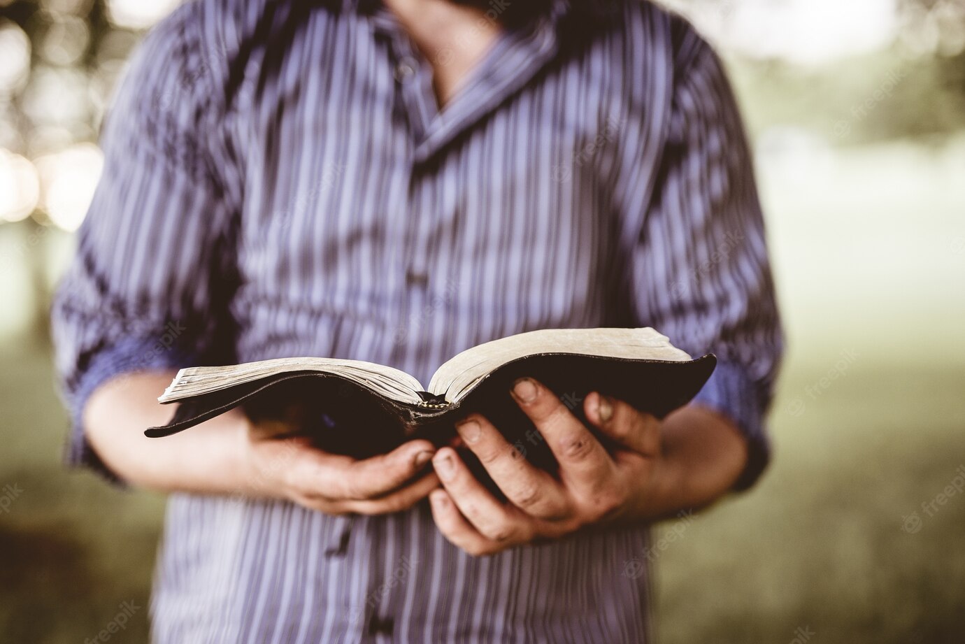 Closeup Shot Male Holding Open Bible With Blurred Background 181624 30840