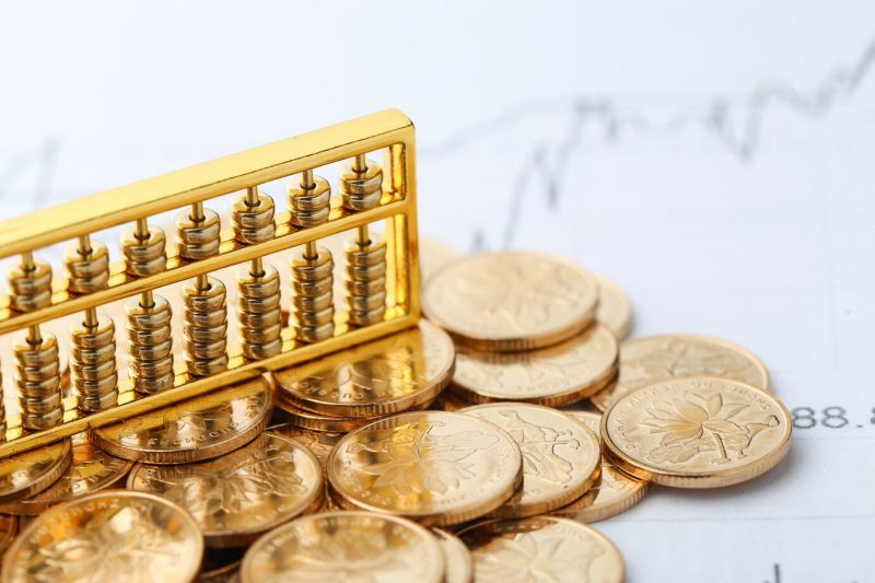 Golden abacus with chinese rmb gold coins as background Free Photo