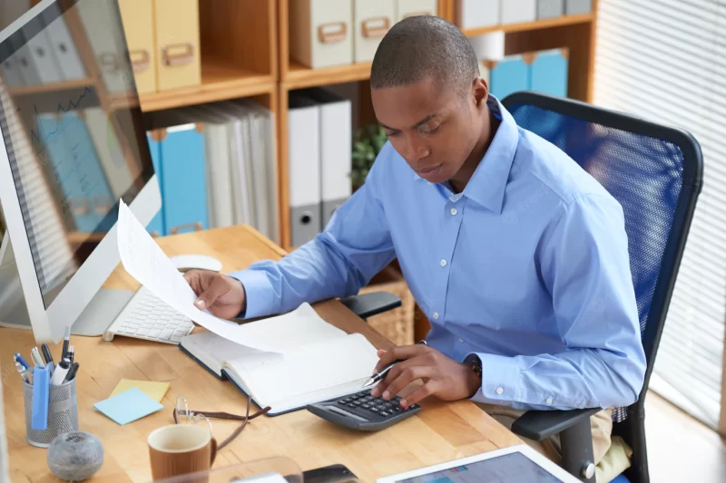 High angle view of male accountant checking financial document Free Photo