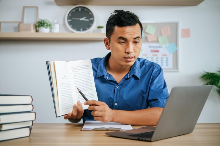 Man Working Office Holding Papers With Laptop Desk 1150 52110