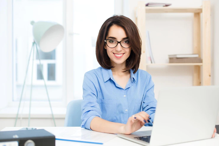 Pretty Brunette Girl Blue Shirt Is Sitting Table Office She Is Working With Laptop Smiling Camera 197531 25026