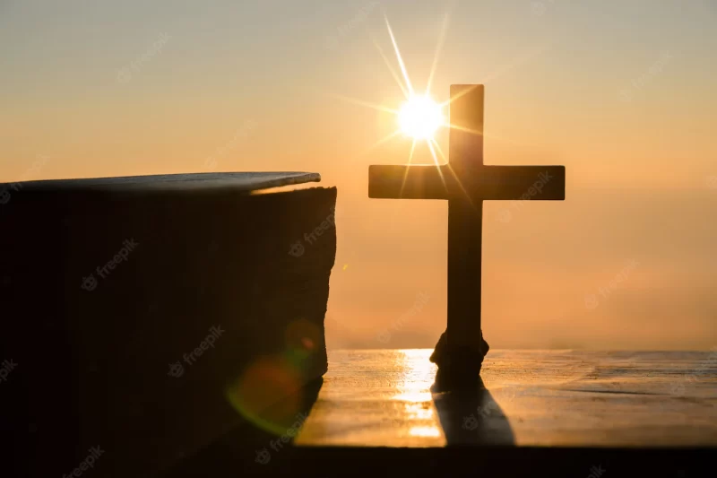 Resurrection of jesus christ concept: silhouette cross on hill sunrise background Free Photo