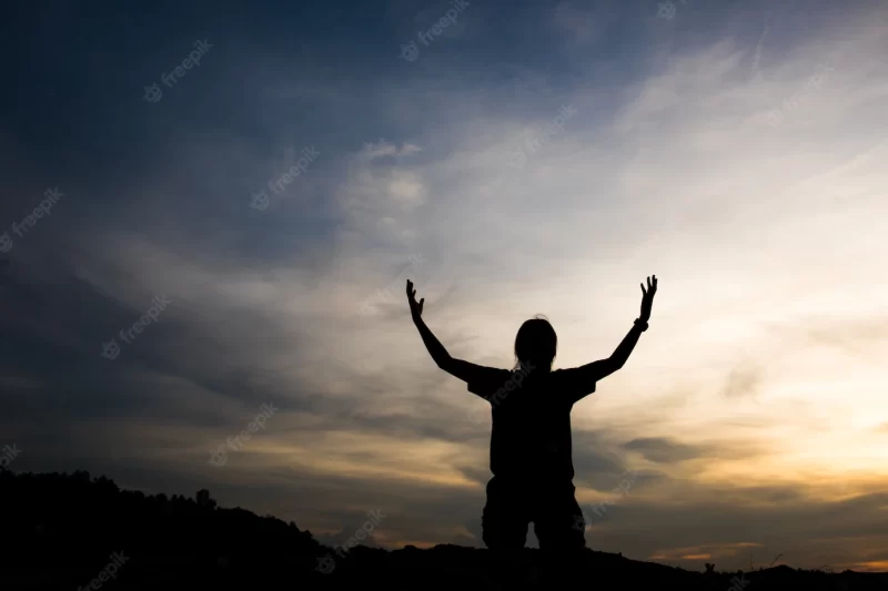 Silhouette of woman praying with god Free Photo