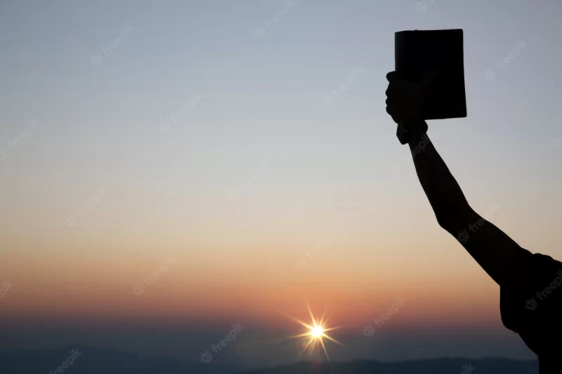 Spiritual prayer hands holding the bible Free Photo