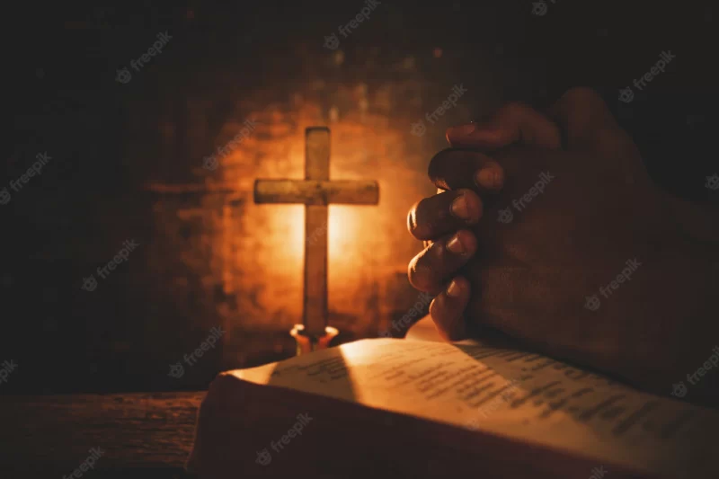 Vintage photo of hand with bible praying Free Photo